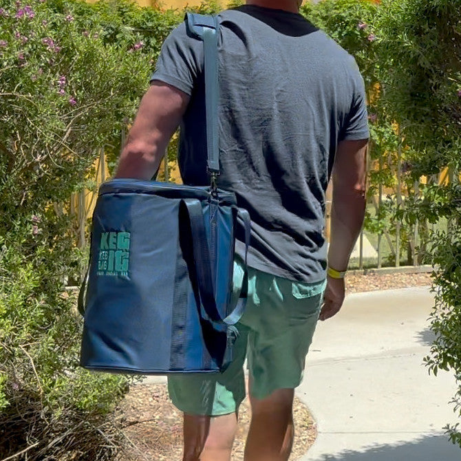 Carrying the packed Keg It Keg Kit to the pool by its shoulder strap